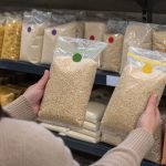 Persona compara alimentos secos envasados en un anaquel compartido