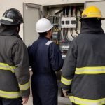 Bomberos revisan un tablero eléctrico durante una capacitación de seguridad